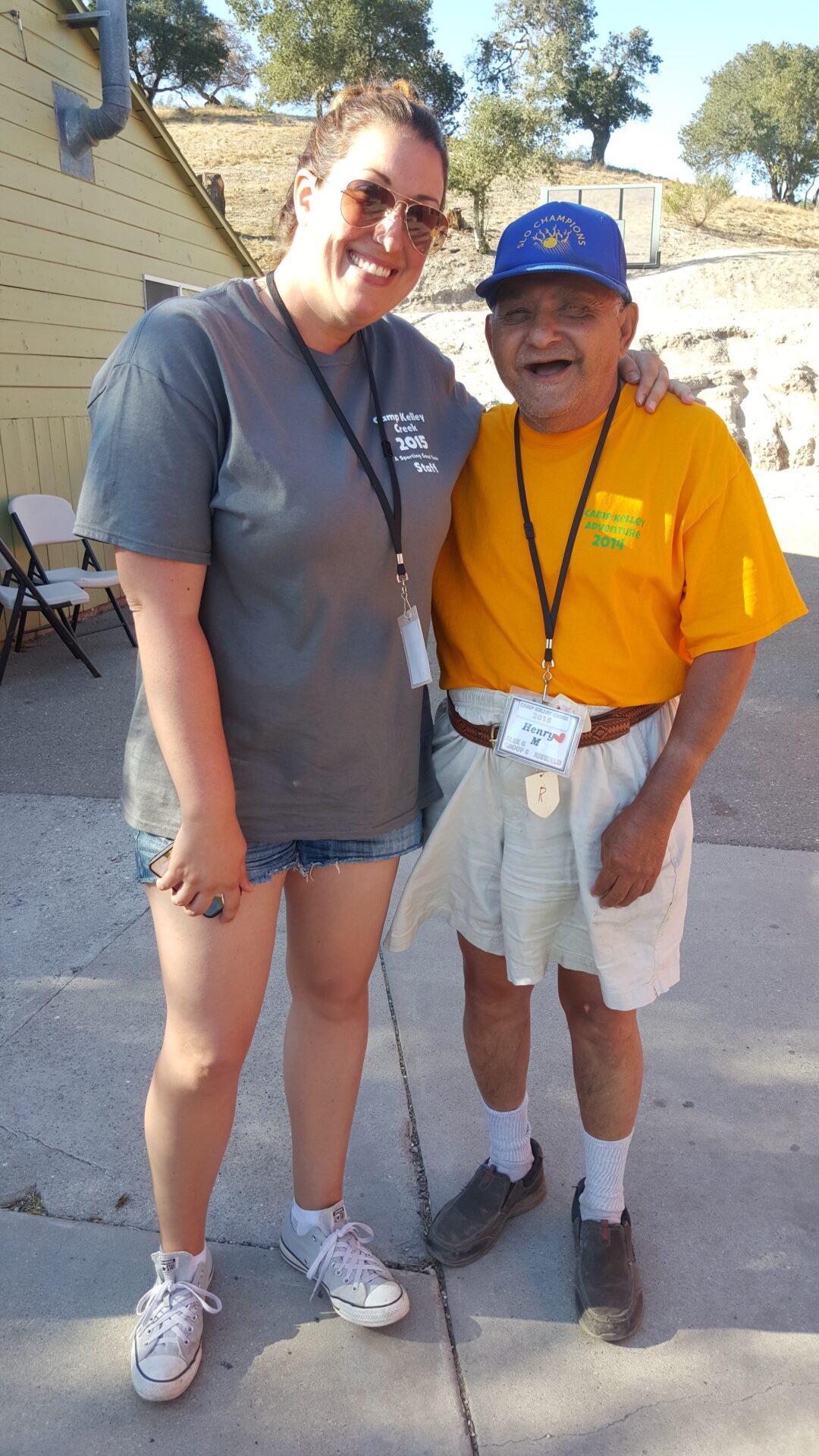 A UCP Member and a UCP Volunteer embracing and smiling at Camp Kelley Creek