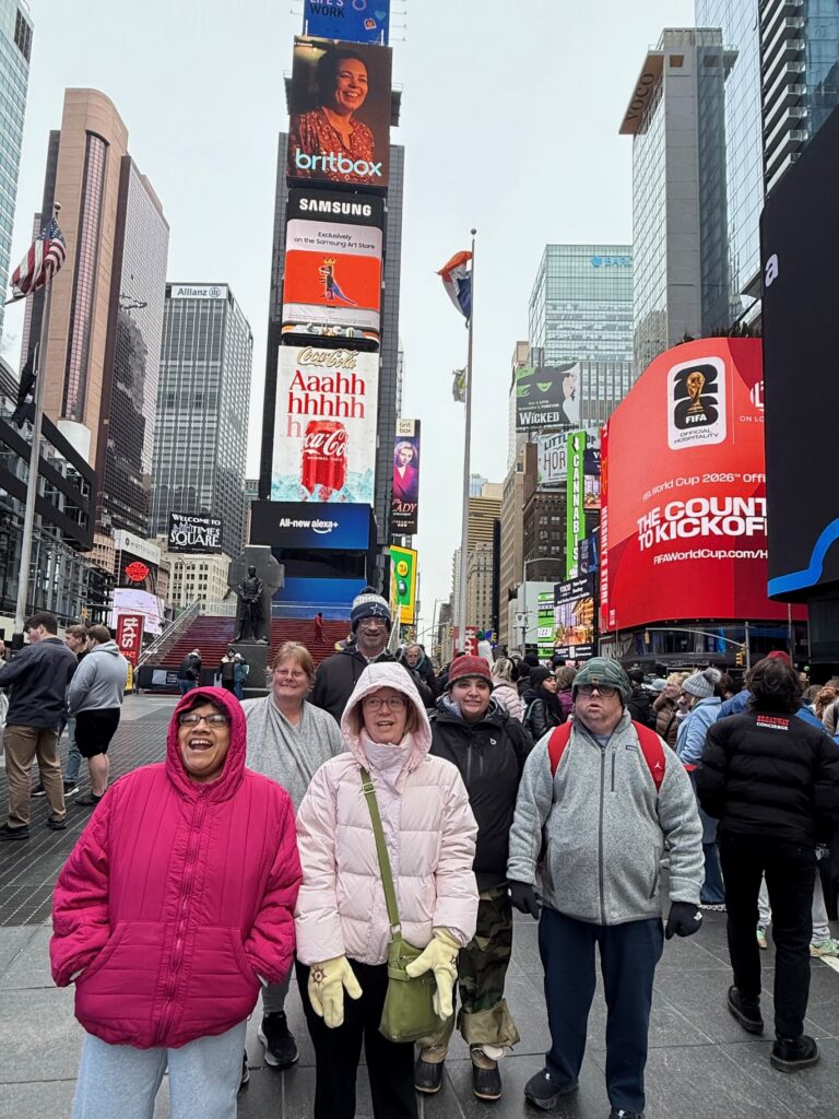 Our 2026 CIP Tour New York crew posing for the camera in Times Square